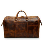 sleek brown cowhide duffle handbags with easy-carry handles and a long zipper.