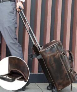 A luggage trolley duffle bag with brown leather, featuring wheels and an extendable handle for easy mobility.