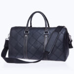 A stylish black quilted leather travel duffel bag with two handles and a detachable shoulder strap.